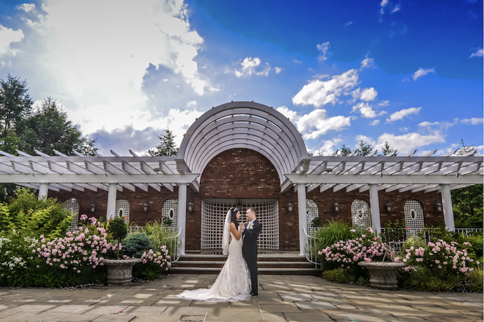Outdoor garden and arbor with bride and groom at Birchwood Manor in Whippany, NJ